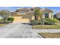 Cute yellow house with a two-car garage at 1848 Bobcat Trl, North Port, FL 34288