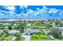 Waterfront property with lush landscaping, a canal view, and nearby homes at 192 Danforth S Dr, Port Charlotte, FL 33980