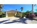 House exterior showcasing a tile roof, landscaping, and attached garage at 220 Shreve St, Punta Gorda, FL 33950