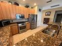 Spacious kitchen featuring stainless steel appliances and granite countertops at 24157 Green Heron Dr # 27, Punta Gorda, FL 33980