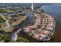 Wide aerial showcasing the condo community's waterfront location and surrounding buildings at 25188 Marion Ave # E103, Punta Gorda, FL 33950