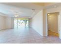 Spacious living room with tile floors, ceiling fan, and sliding glass doors to a covered balcony at 255 W End Dr # 4210, Punta Gorda, FL 33950