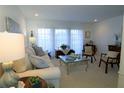 Living room with beige couch, wicker chairs, and a coffee table at 3000 Peace River Dr, Punta Gorda, FL 33983