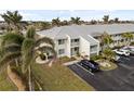 Condo building exterior with lush landscaping and parking at 3600 Bal Harbor Blvd # 1A, Punta Gorda, FL 33950