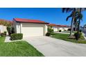 Attached garage with driveway and landscaping at 3830 Bal Harbor Blvd # 5, Punta Gorda, FL 33950