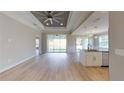 Open floor plan with light wood flooring, high ceilings, and an island kitchen at 4393 Antioch St, North Port, FL 34288