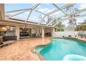 Inviting kidney-shaped pool with a screened enclosure and patio area at 5273 Crestline Ter, Port Charlotte, FL 33981