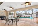 Covered patio with a dining table overlooking the pool at 5273 Crestline Ter, Port Charlotte, FL 33981