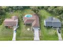 Three houses are shown with a pool in the center house's backyard at 813 Thornton Nw Ave, Port Charlotte, FL 33948