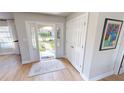 Light and airy entryway with hardwood floors, neutral colors, and access to a hallway at 1022 Lucia Dr, Punta Gorda, FL 33950