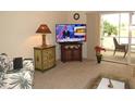 Living room with TV, sofa, and side tables at 1246 Rio De Janeiro Ave # 503, Punta Gorda, FL 33983