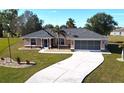 Single story house with driveway and palm trees at 16129 Coruna Ct, Punta Gorda, FL 33955
