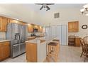 Bright kitchen with stainless steel appliances and an oak wood breakfast bar at 17456 Foremost Ln, Port Charlotte, FL 33948