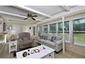 Relaxing living room featuring a comfortable sofa and arm chair, with large windows at 19071 Helena Ave, Port Charlotte, FL 33948