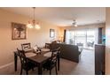 Bright dining area with a four-person table and access to the living room at 19375 Water Oak Dr # 203, Port Charlotte, FL 33948