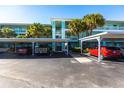 Covered parking area with several cars parked underneath at 19375 Water Oak Dr # 203, Port Charlotte, FL 33948