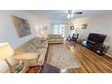 Living room with hardwood floors, comfy seating and access to patio at 22375 Edgewater Dr # 147, Punta Gorda, FL 33980