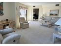 Spacious living room with ample seating and natural light at 25188 Marion Ave # F201, Punta Gorda, FL 33950