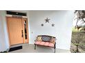 Charming front porch featuring a comfortable bench and decorative stars at 26166 Stillwater Cir, Punta Gorda, FL 33955