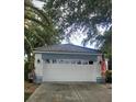 Attached garage with white door and tile roof at 26166 Stillwater Cir, Punta Gorda, FL 33955