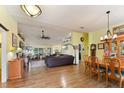 Bright dining room with hardwood floors and wooden dining set at 26572 Trinilas Dr, Punta Gorda, FL 33983