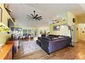 Spacious living room with hardwood floors, comfy seating, and large TV at 26572 Trinilas Dr, Punta Gorda, FL 33983