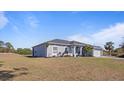 Gray house with a gray roof, white columns, and a two-car garage at 2668 Clovelon St, North Port, FL 34291