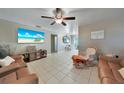 Spacious living area with large TV, comfortable seating, and an open floor plan at 27131 Ann Arbor Ave, Punta Gorda, FL 33983