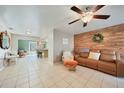 Open living space with a view into the kitchen and a comfy rocking chair at 27131 Ann Arbor Ave, Punta Gorda, FL 33983