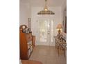 Front entry with decorative door and hardwood floors at 273 Mark Twain Ln, Rotonda West, FL 33947
