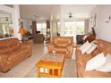 Spacious living room with leather sofas and a coffee table at 273 Mark Twain Ln, Rotonda West, FL 33947