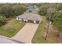 Single-story home with a three-car garage and spacious driveway at 3495 Levee St, North Port, FL 34288