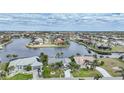 Aerial view of a waterfront community with lush landscaping and many houses at 4072 San Massimo Dr, Punta Gorda, FL 33950