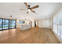 Open living space with wood flooring and access to kitchen at 4072 San Massimo Dr, Punta Gorda, FL 33950