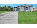 New construction home featuring a gray exterior and concrete driveway at 4629 Enid Ln, North Port, FL 34288