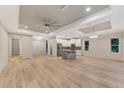Open living space with high ceilings, hardwood floors, and kitchen island at 4629 Enid Ln, North Port, FL 34288