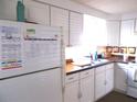 Bright kitchen with white cabinets, laminate countertops, and appliances at 5232 Palena Blvd, North Port, FL 34287