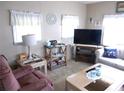 Living room features a large TV and comfy seating at 5733 Holiday Park Blvd, North Port, FL 34287