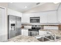 Modern kitchen with stainless steel appliances at 7177 Dateland St, Englewood, FL 34224