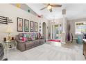 Comfortable living room featuring a gray sectional sofa and a ceiling fan at 1020 Caliva St, North Port, FL 34286