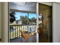 Private balcony with table and chairs overlooking the pool at 1051 Forrest Nelson Blvd # M-203, Port Charlotte, FL 33952