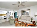 Living room features a sofa, armchair, and large artwork at 1051 Forrest Nelson Blvd # 203, Port Charlotte, FL 33952