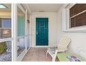 Relaxing screened porch with teal door and seating area at 1075 Messina Dr, Punta Gorda, FL 33950