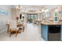 Bright dining room with wood table and six chairs, adjacent to kitchen and living room at 1259 Backspin Dr, Englewood, FL 34223