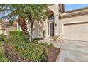 House entrance with screen door, landscaping, and walkway at 13147 Preserve Ct, Port Charlotte, FL 33953