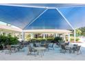 Covered patio with tables and chairs near pool at 13147 Preserve Ct, Port Charlotte, FL 33953