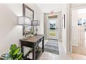 Bright entryway with console table, lamps, and mirror at 1422 Powell Valley Dr, Port Charlotte, FL 33953