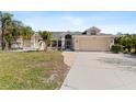 Charming single-story home featuring a 2-car garage, well-maintained lawn, and tropical landscaping at 154 Catamaraca Ct, Punta Gorda, FL 33983