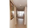 Light and bright hallway with tile flooring, leading to living area and balcony view at 1601 Park Beach Cir # 125/11, Punta Gorda, FL 33950