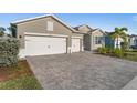 Two-story house with a paver driveway and two-car garage at 17638 Palmetto Pass Ln, Punta Gorda, FL 33982